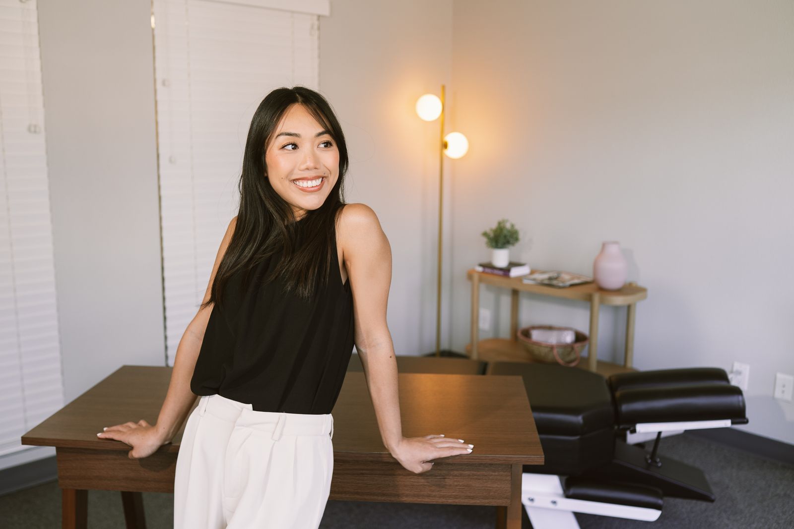 Dr. Kelly smiling in front of her office workspace