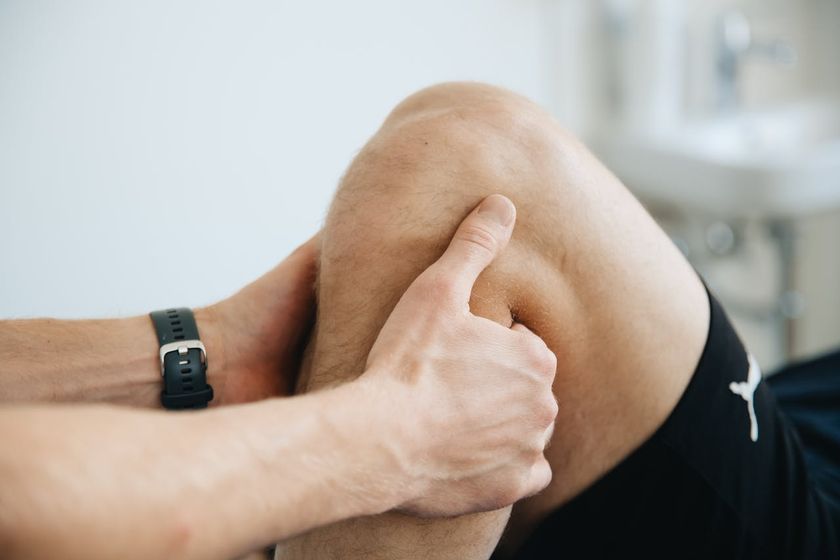 Man getting leg adjusted to relieve knee pain